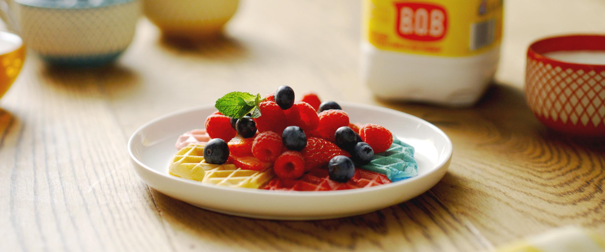 Rainbow waffles topped with berries and mint