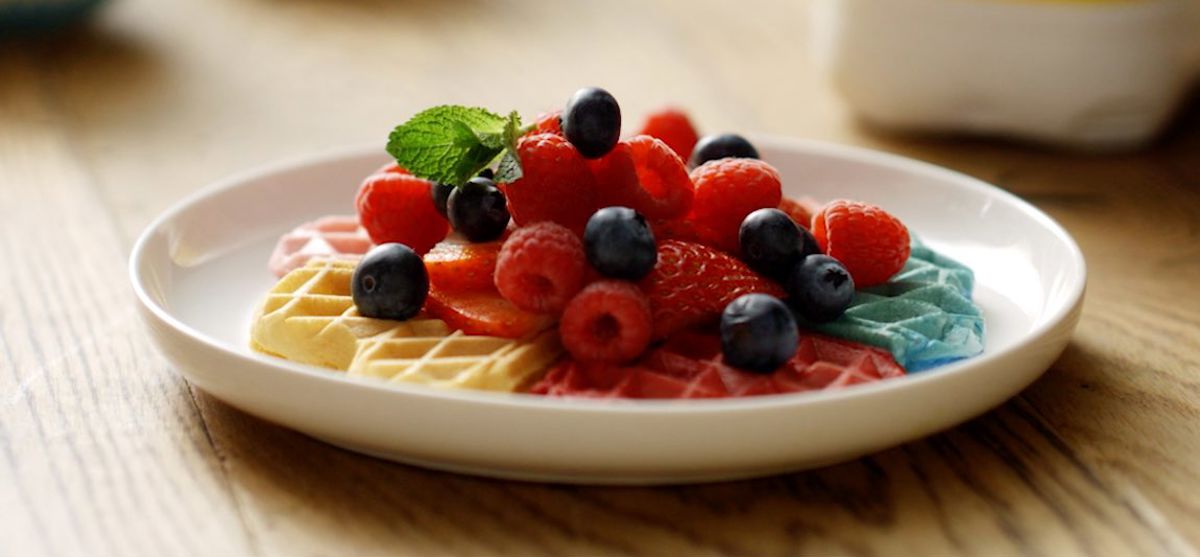 Rainbow waffles topped with berries and mint