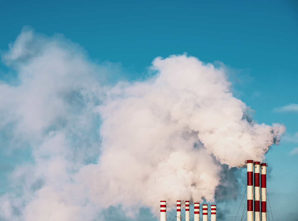 Industrial stacks billowing smoke